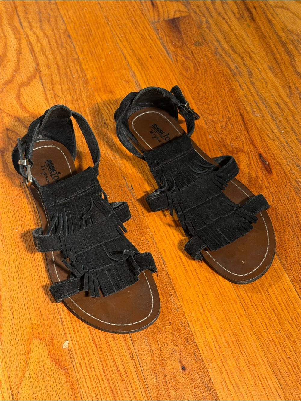 Minetonka Suede Fringe T-Strap Black Sandals